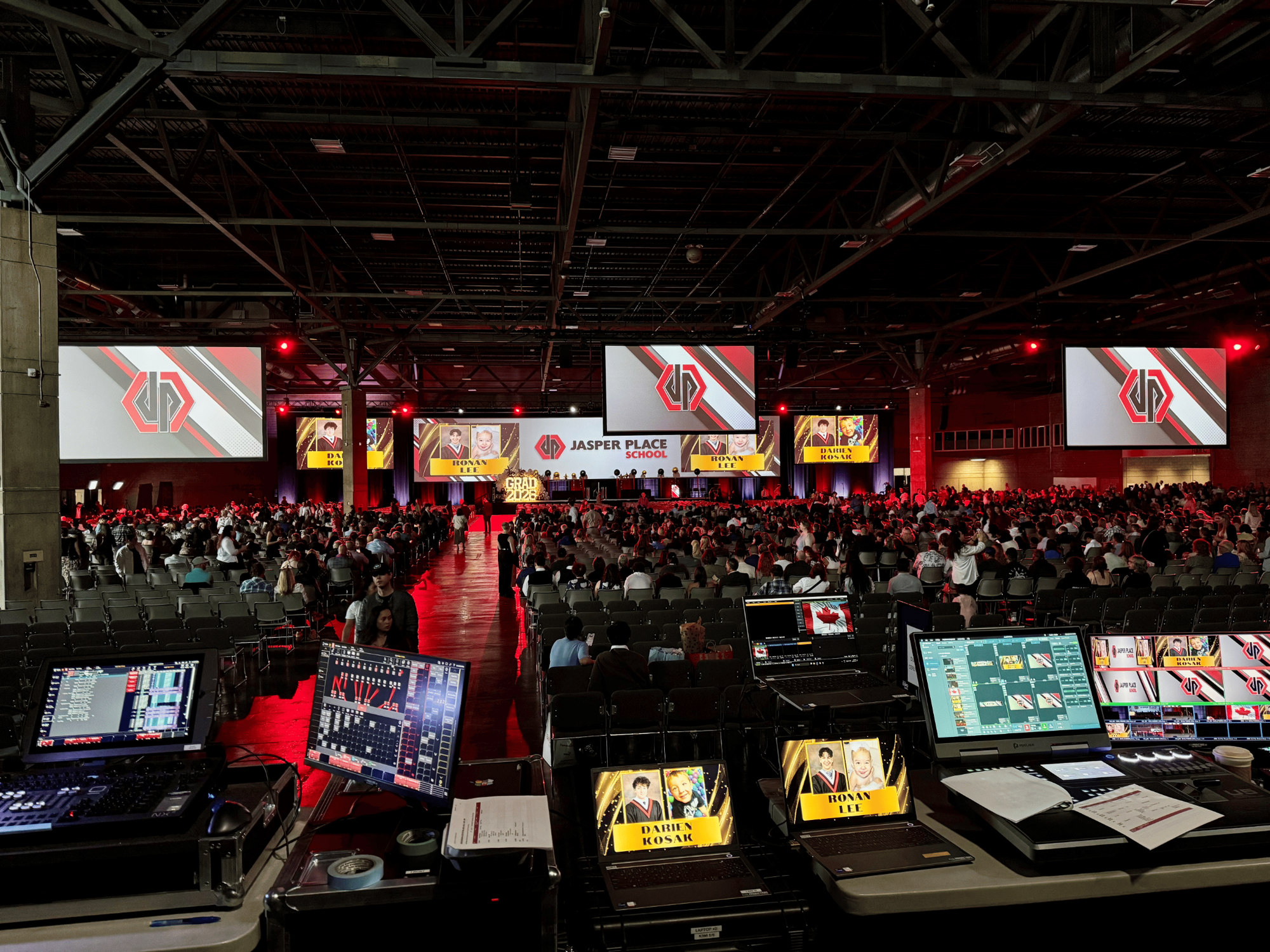 Jasper Place High School graduation ceremony at Edmonton EXPO Centre featuring large projection screens, stage lighting and AV production by Kiwi Productions.